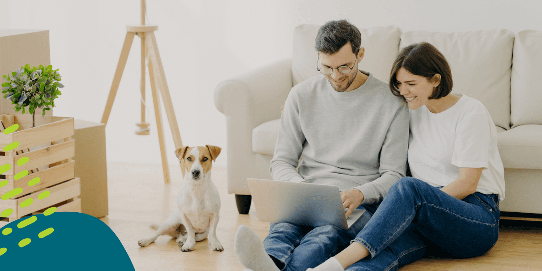 Couple with dog looking at computer